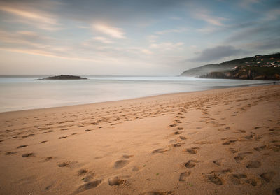 Scenic view of beach against sky during sunset