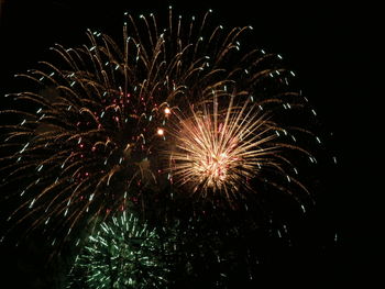 Low angle view of firework display at night