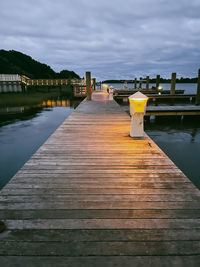 Pier over lake against sky