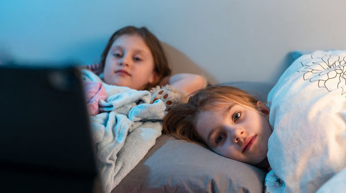 Portrait of cute girl relaxing on bed at home