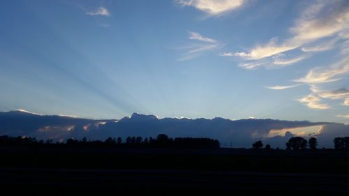 Scenic view of silhouette mountains against sky at sunset