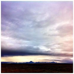 Scenic view of landscape against cloudy sky