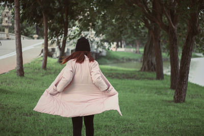 Rear view of woman on field