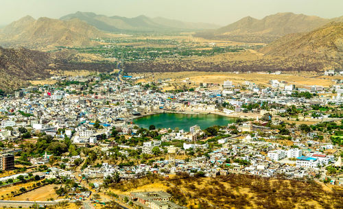 High angle view of townscape and river in city