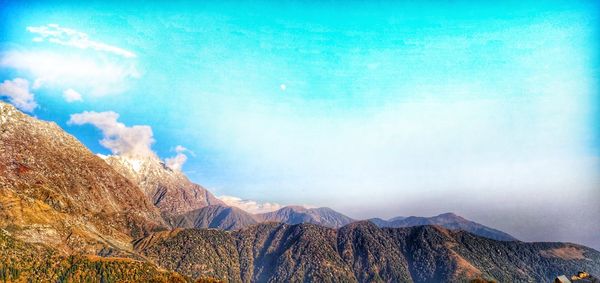 Panoramic view of mountain range against cloudy sky