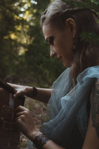 Close up pleased female druid unlocking puzzle box portrait picture