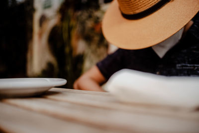 Close-up of person sitting on table