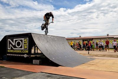 Man skateboarding on skateboard against sky