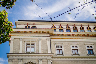 Low angle view of building against cloudy sky