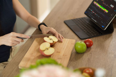 Midsection of man preparing food on table