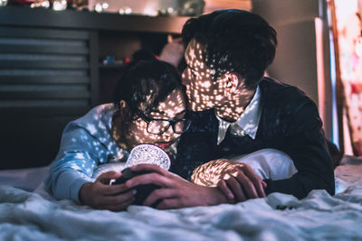 Young couple lying on bed at home