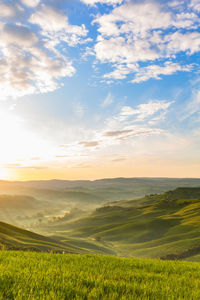 Sunrise in the rolling hills with mist in the valley