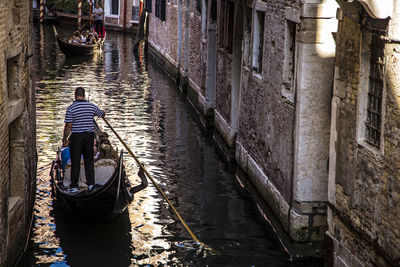 Rear view of man in canal