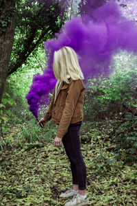 Woman standing on purple flower tree