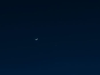 Low angle view of moon against clear sky at night