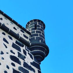 Low angle view of modern building against clear blue sky