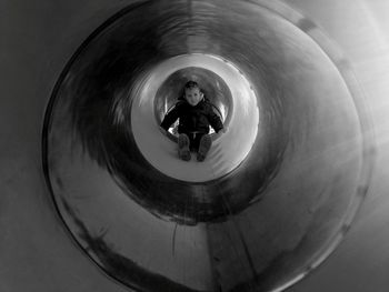 Boy playing in tunnel