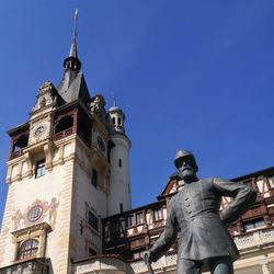 Low angle view of statue against blue sky