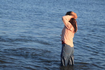 A girl with black hair is standing alone on ammani beach