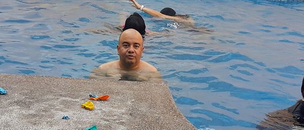 High angle view of boy swimming in pool