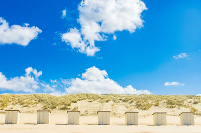 Low angle view of land against blue sky