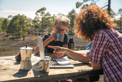 Women sitting on table at outdoor restaurant