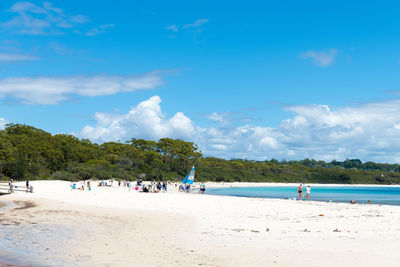 People on beach against sky