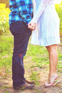 Low section of couple standing outdoors