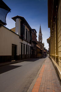 Street amidst buildings against sky in city