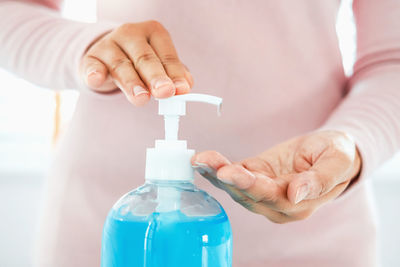 Midsection of man washing hands