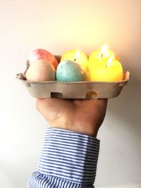 Close-up of hand holding multi colored candies