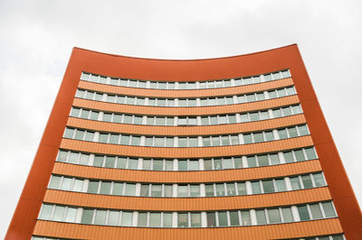 Orange and curved multistorey apartment houses
