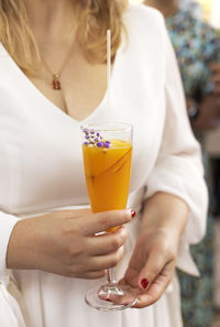 Midsection of woman holding drink