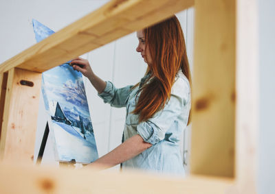 Woman holding window at home