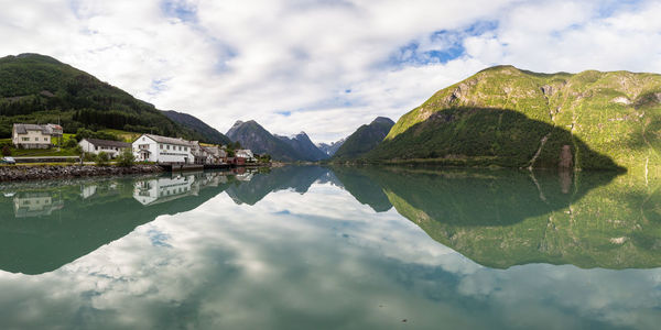 Scenic reflection of mountains and clouds in lake