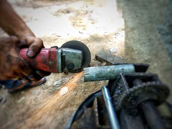 High angle view of man working on metal