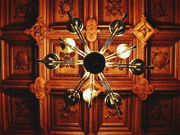 Low angle view of chandelier hanging on ceiling