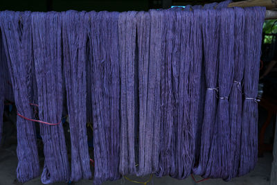 Close-up of wooden post hanging on wood