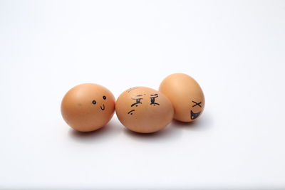 Close-up of eggs against white background