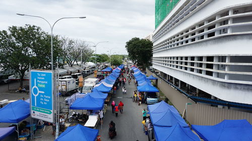 Panoramic view of people in city against sky