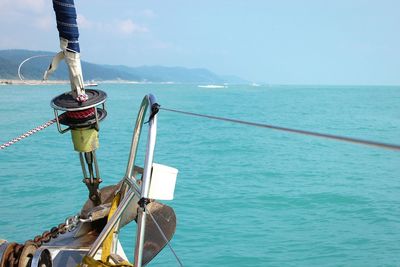 Close-up of rope in sea against sky