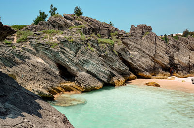 Rock formations in sea against sky