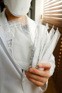 Close-up of hand holding white umbrella