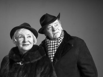 Close-up friends standing against gray background