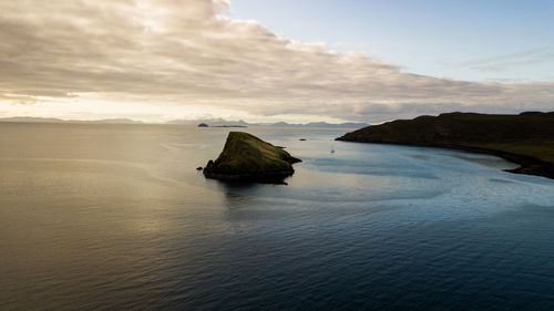 Scenic view of bay against sky during sunset