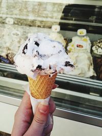 Close-up of hand holding ice cream cone