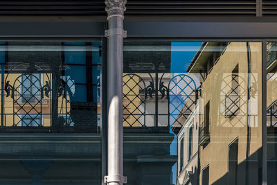 Low angle view of reflection in window of a  building