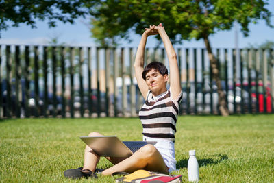 Portrait of young woman sitting on grass