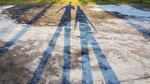 High angle view of people shadow on street