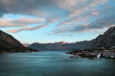 Scenic view of mountains, sunset, and water